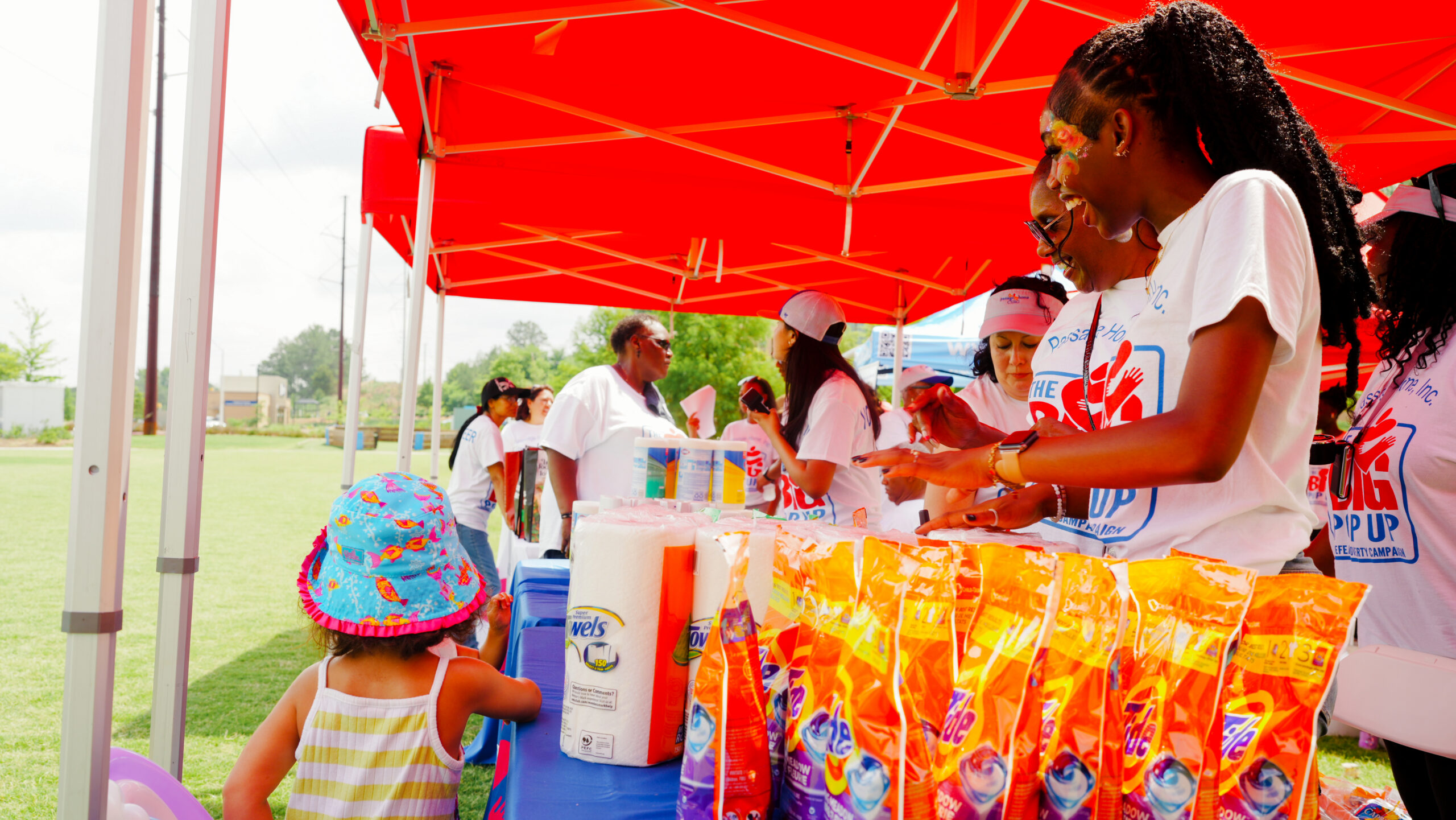 Passage Home team distributing household supplies at an outdoor community event