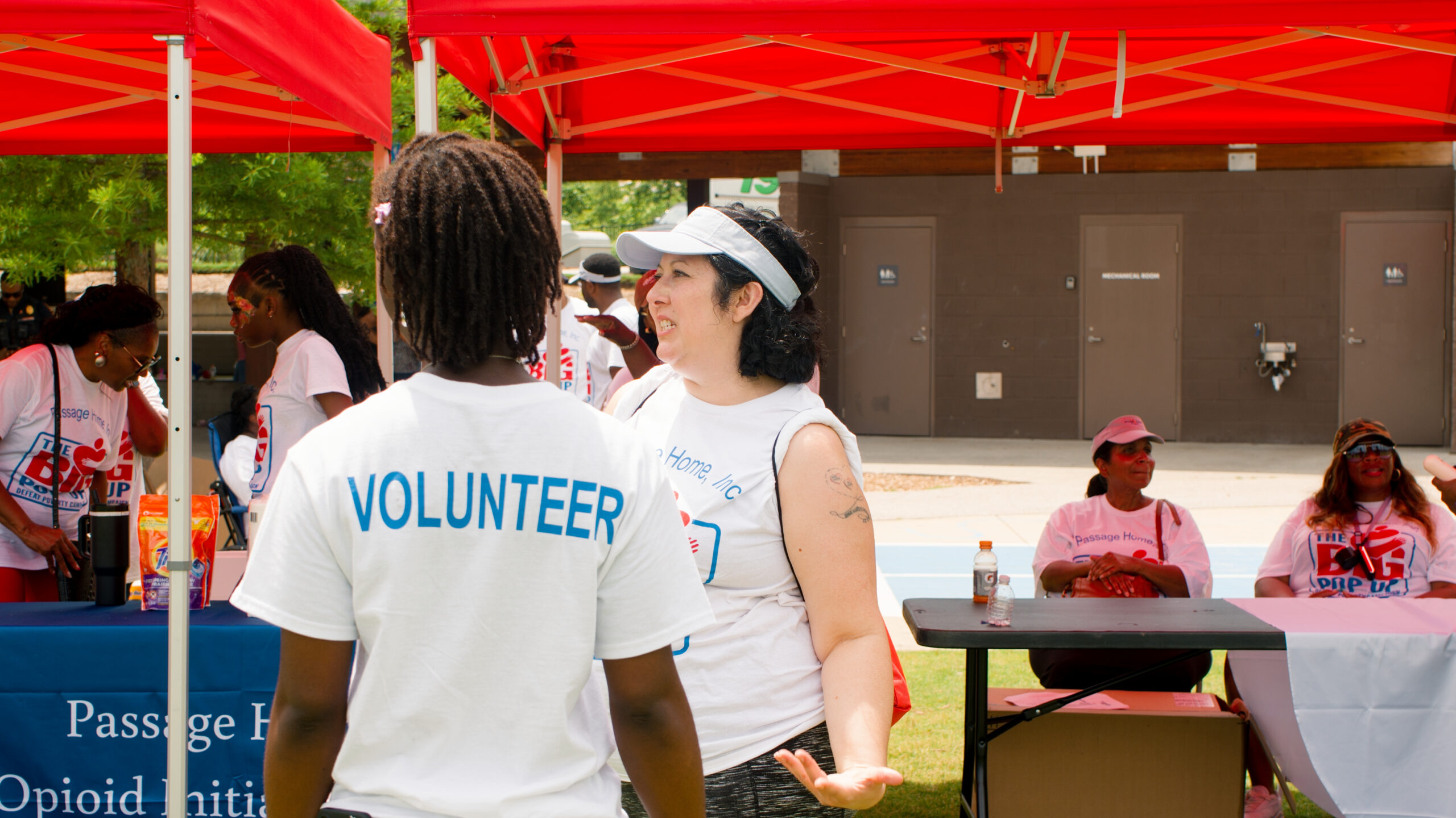 Passage Home volunteers connecting at a community event
